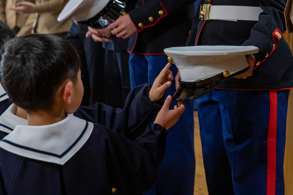 Graduation: Volunteers from Marine Corps Air Station Iwakuni hand out graduation certificates