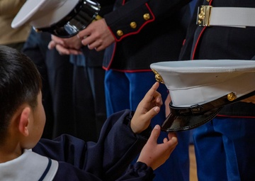 Graduation: Volunteers from Marine Corps Air Station Iwakuni hand out graduation certificates
