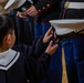 Graduation: Volunteers from Marine Corps Air Station Iwakuni hand out graduation certificates