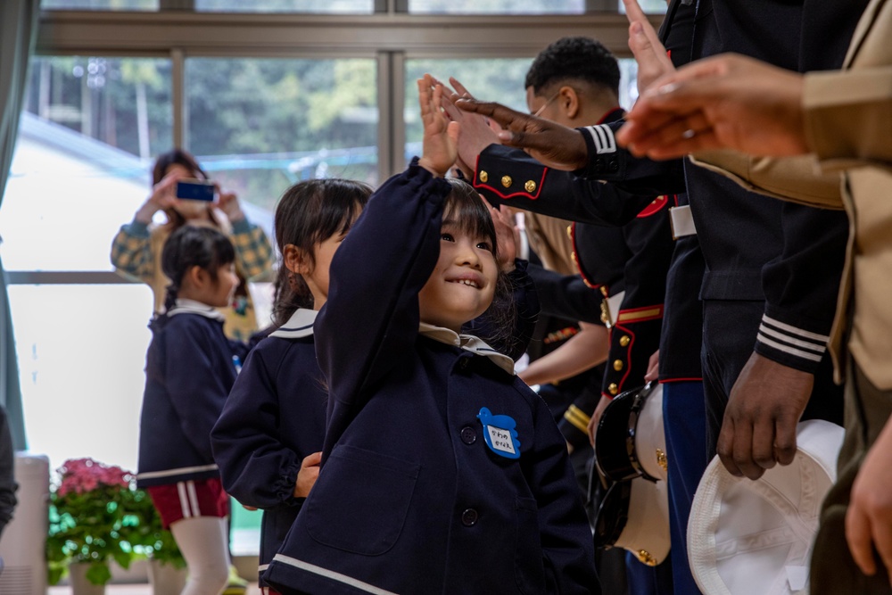 Graduation: Volunteers from Marine Corps Air Station Iwakuni hand out graduation certificates