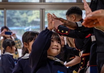Graduation: Volunteers from Marine Corps Air Station Iwakuni hand out graduation certificates