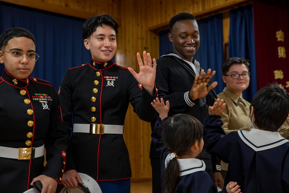 Graduation: Volunteers from Marine Corps Air Station Iwakuni hand out graduation certificates