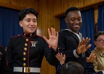 Graduation: Volunteers from Marine Corps Air Station Iwakuni hand out graduation certificates