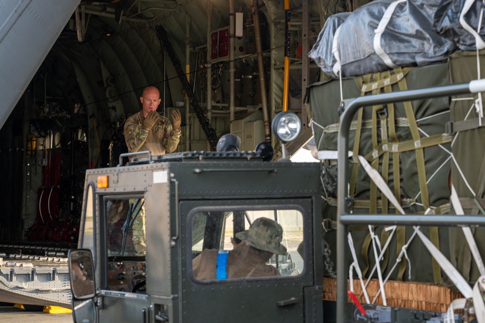Airmen load AFCENT C-130s with humanitarian aid bound for Gaza