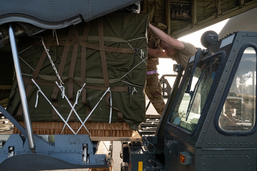 Airmen load AFCENT C-130s with humanitarian aid bound for Gaza