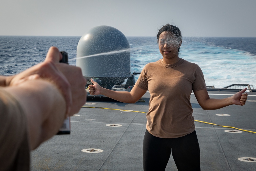USS Mobile (LCS 26) Gold Crew sailors receive OC spray, demonstrate security force skills