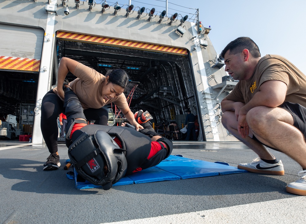 USS Mobile (LCS 26) Gold Crew sailors receive OC spray, demonstrate security force skills
