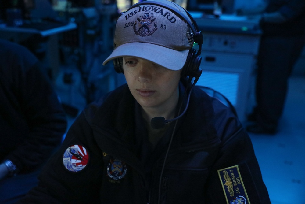 Sailors aboard the USS Howard conduct a surface warfare exercise in the Philippine Sea