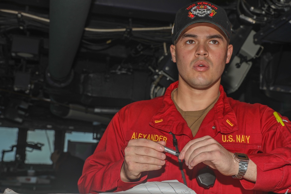 Sailors aboard the USS Howard conduct a surface warfare exercise in the Philippine Sea