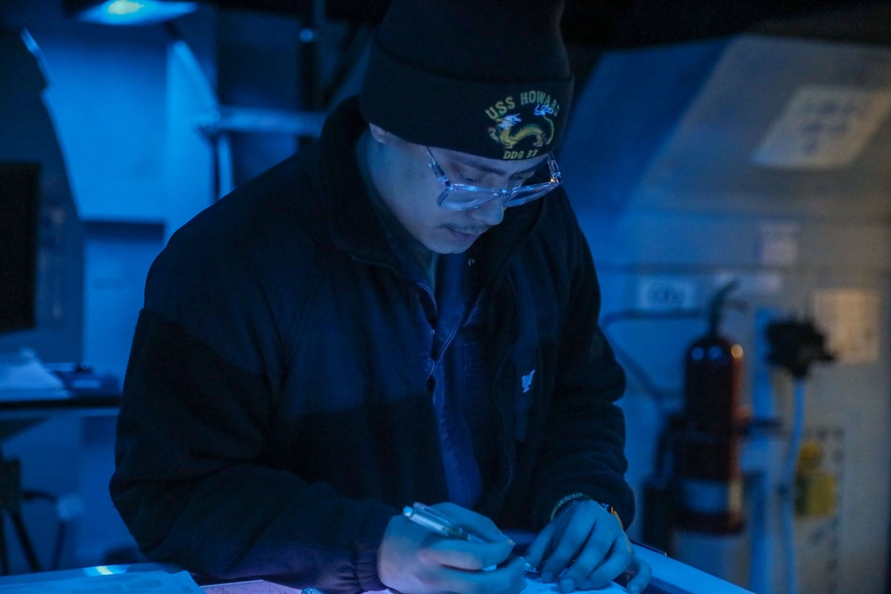 Sailors aboard the USS Howard conduct a surface warfare exercise in the Philippine Sea