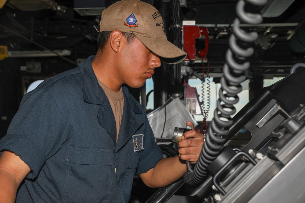 Sailors aboard the USS Howard conduct a surface warfare exercise in the Philippine Sea