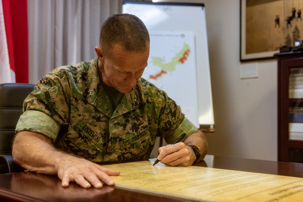 MajGen Liszewski signs the Child Abuse Prevention Month proclamation on Camp Foster