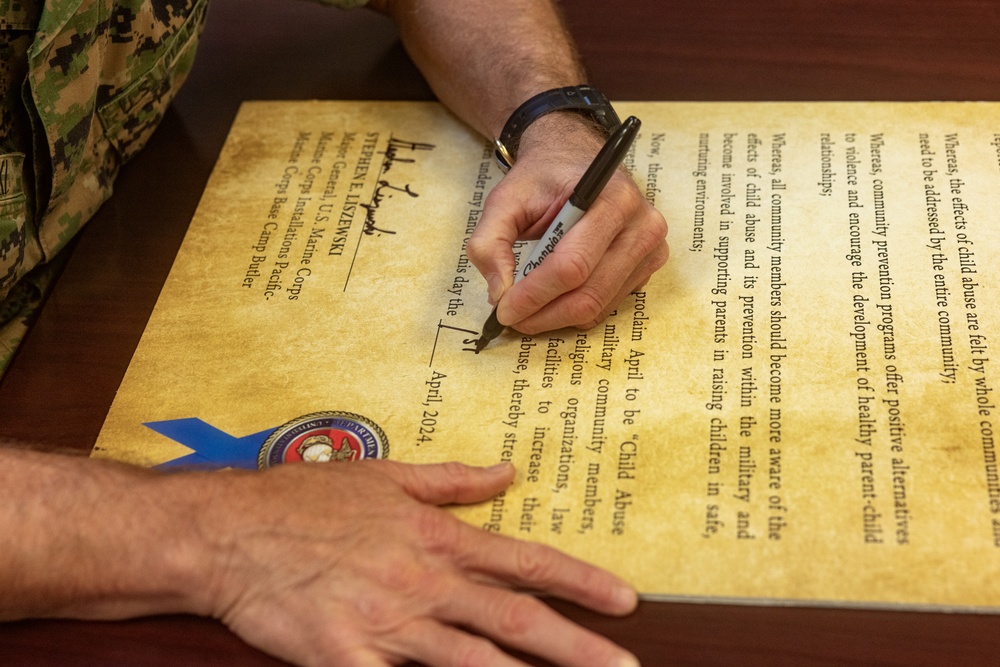 MajGen Liszewski signs the Child Abuse Prevention Month proclamation on Camp Foster