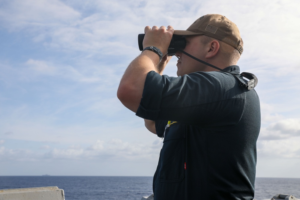 Sailors aboard the USS Howard stand watch during a surface action group exercise in the Philippine Sea