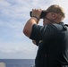 Sailors aboard the USS Howard stand watch during a surface action group exercise in the Philippine Sea