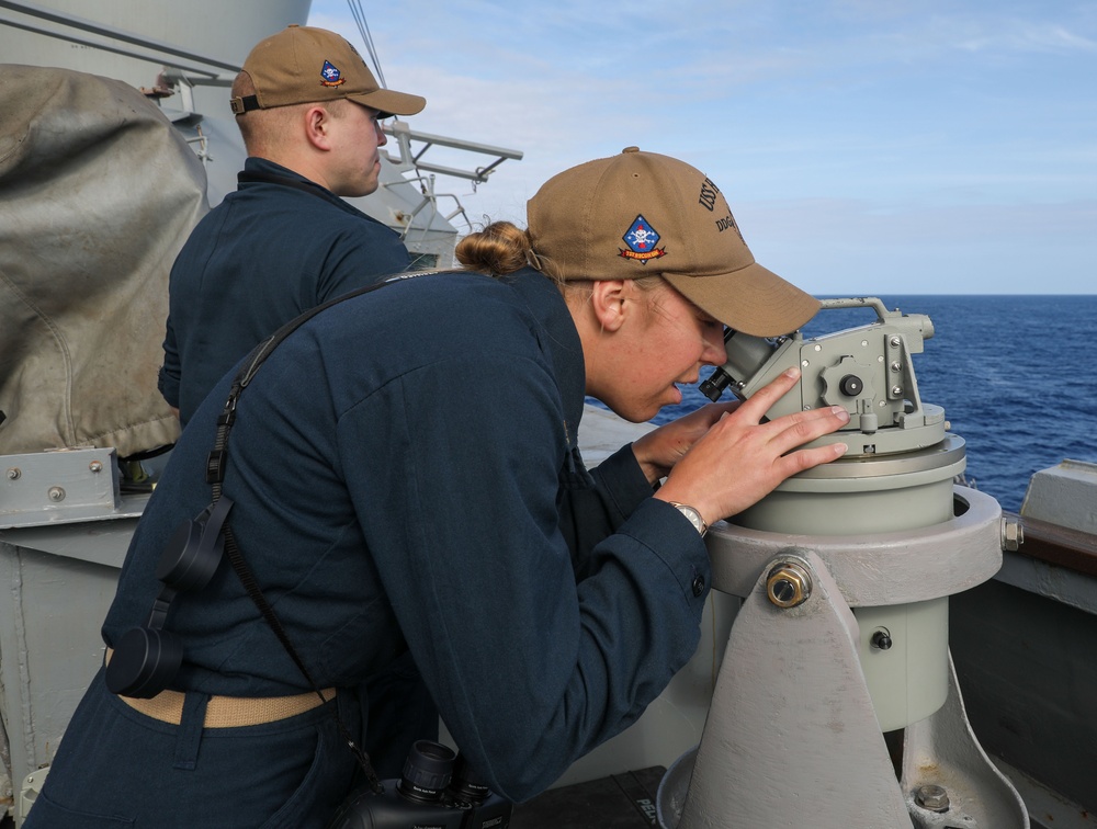 Sailors aboard the USS Howard stand watch during a surface action group exercise in the Philippine Sea