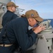 Sailors aboard the USS Howard stand watch during a surface action group exercise in the Philippine Sea