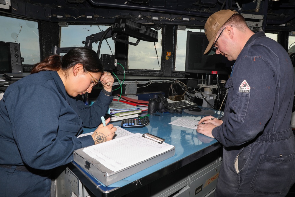 Sailors aboard the USS Howard stand watch during a surface action group exercise in the Philippine Sea