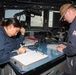 Sailors aboard the USS Howard stand watch during a surface action group exercise in the Philippine Sea