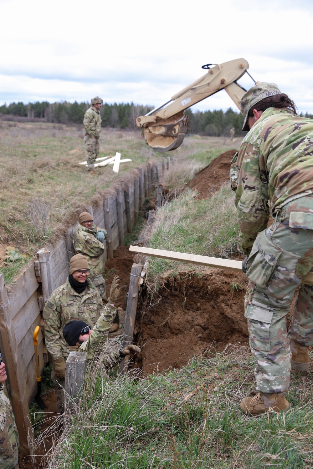 Engineers build and maintain trenches in training area