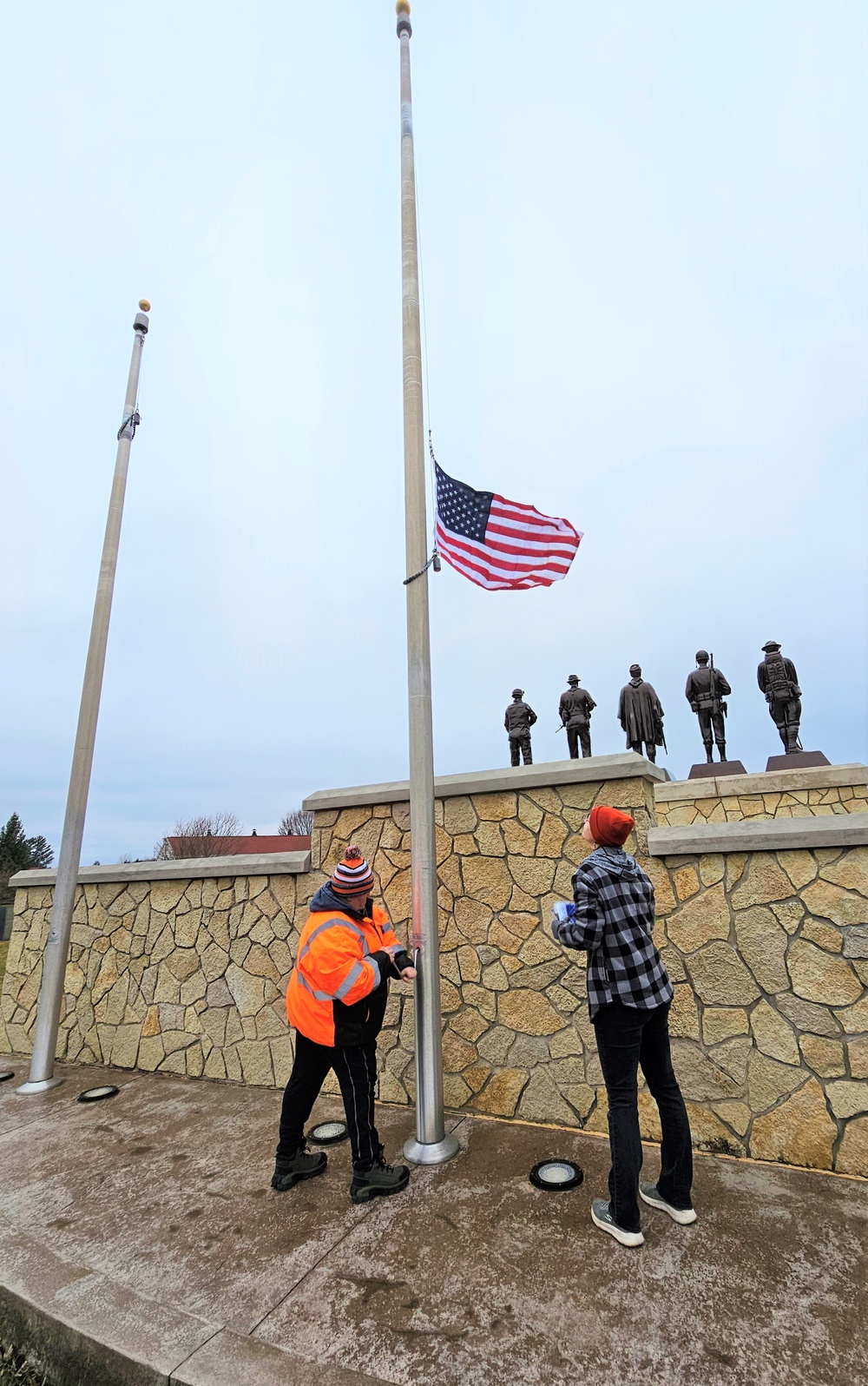 Raising flag at Fort McCoy's Veterans Memorial Plaza