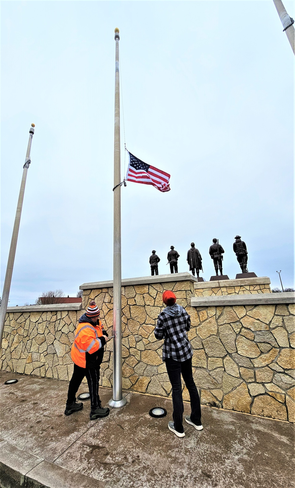 Raising flag at Fort McCoy's Veterans Memorial Plaza