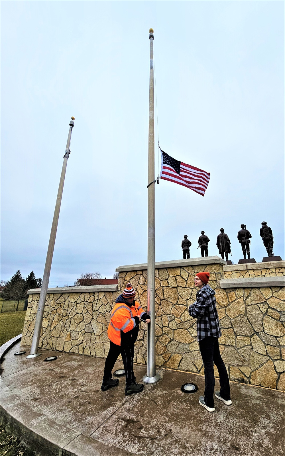 Raising flag at Fort McCoy's Veterans Memorial Plaza