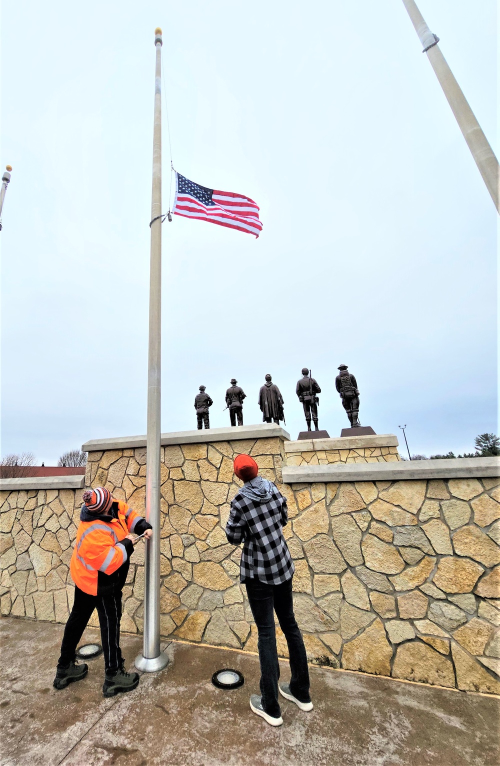 Raising flag at Fort McCoy's Veterans Memorial Plaza