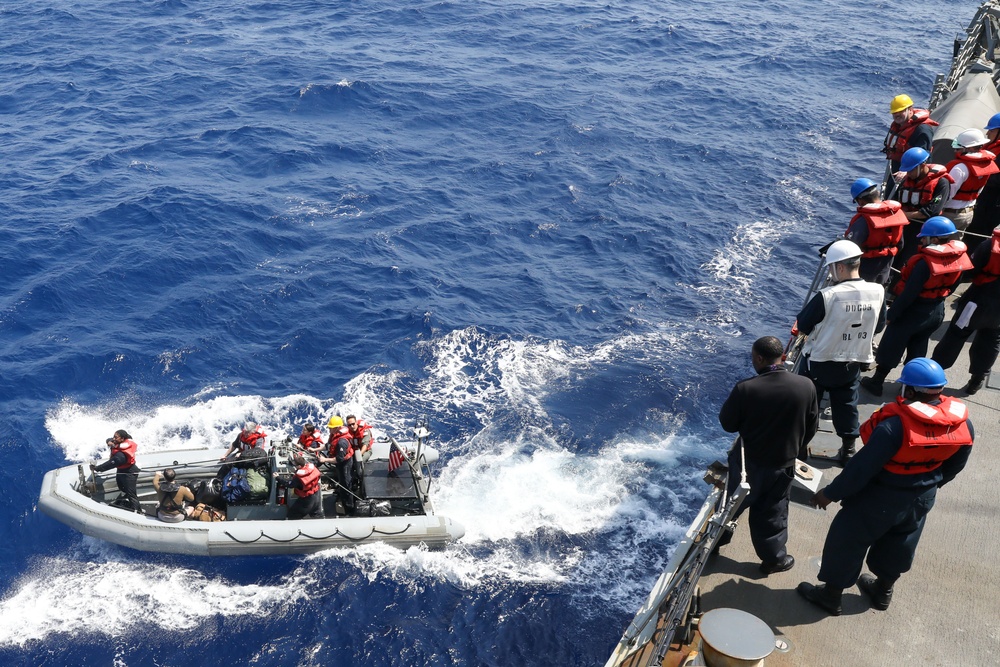 Sailors aboard the USS Howard conduct boat operations in the Philippine Sea