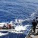 Sailors aboard the USS Howard conduct boat operations in the Philippine Sea