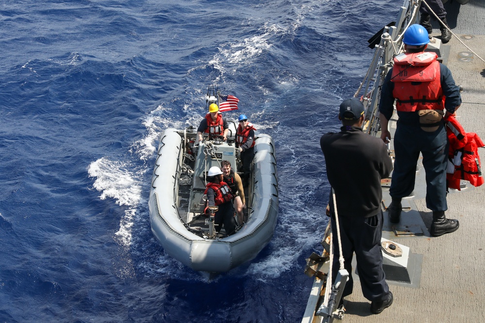 Sailors aboard the USS Howard conduct boat operations in the Philippine Sea