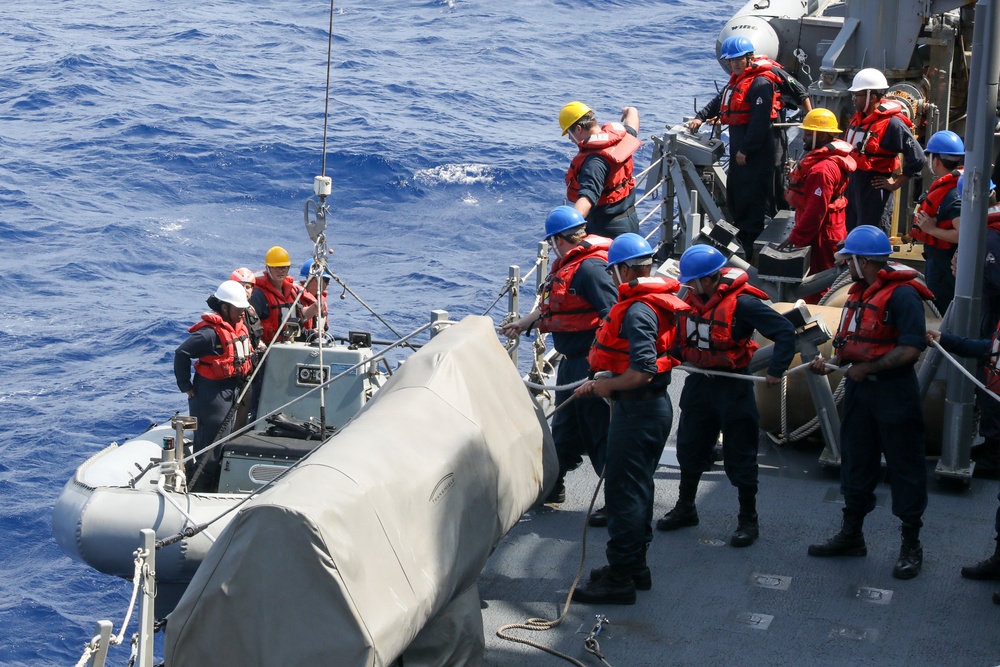 Sailors aboard the USS Howard conduct boat operations in the Philippine Sea