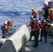 Sailors aboard the USS Howard conduct boat operations in the Philippine Sea