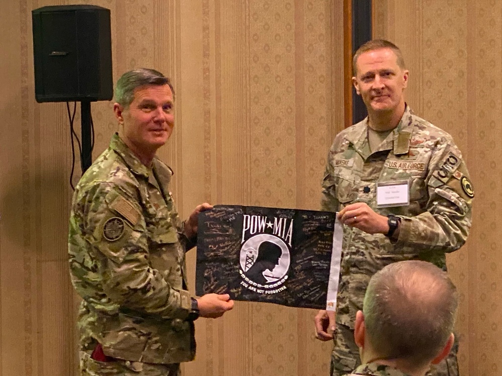 Maj. Gen. Claude Tudor and Lt. Col. Niul Manske Display the POW Flag During The Warfighter Recovery Network Symposium