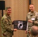 Maj. Gen. Claude Tudor and Lt. Col. Niul Manske Display the POW Flag During The Warfighter Recovery Network Symposium