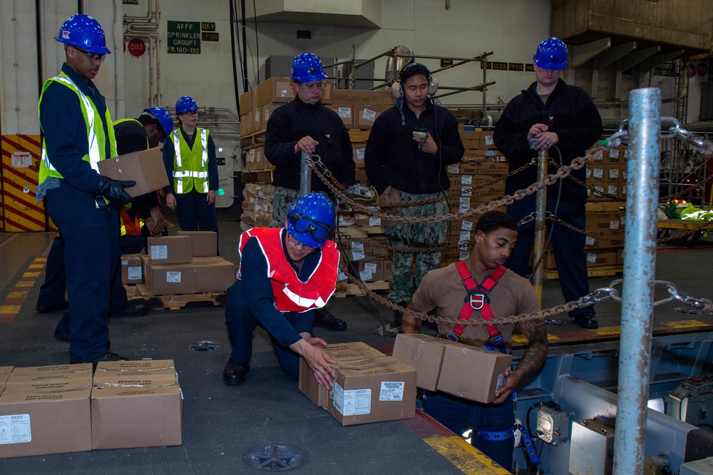 USS Ronald Reagan (CVN 76) Sailors move cargo