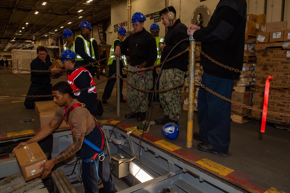 USS Ronald Reagan (CVN 76) Sailors move cargo