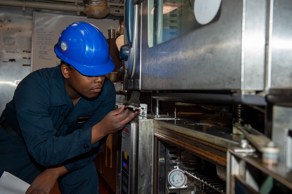 USS Ronald Reagan (CVN 76) Sailors perform maintenance on steam convection oven