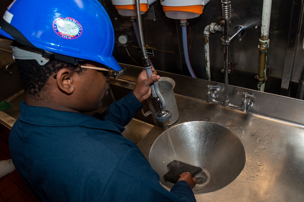 USS Ronald Reagan (CVN 76) Sailors perform maintenance on steam convection oven