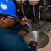 USS Ronald Reagan (CVN 76) Sailors perform maintenance on steam convection oven