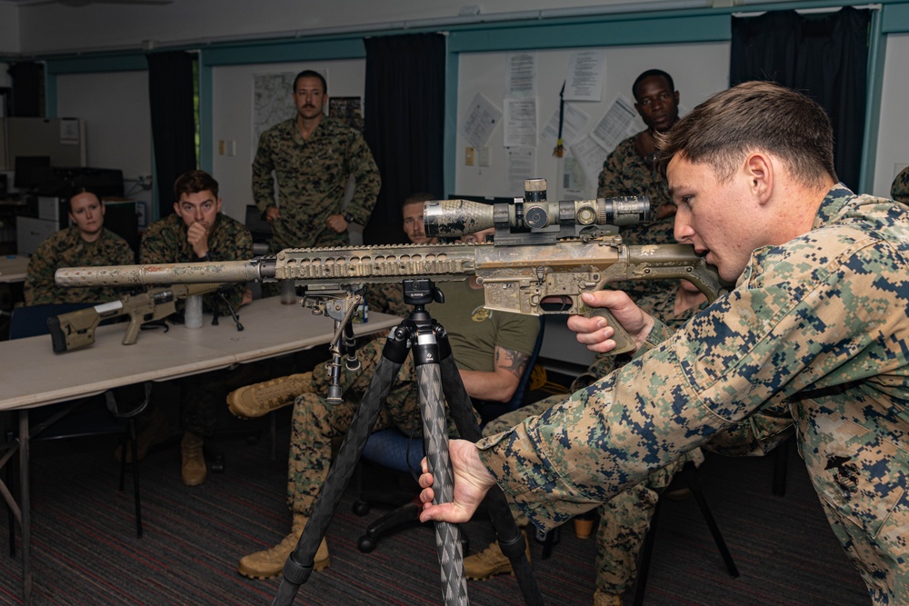 Marines with 2nd Bn., 5th Marines teach EOD technicians about the M110 SASS