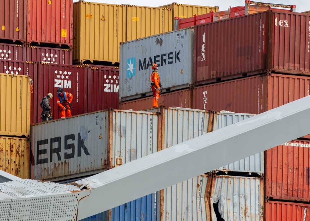 Crews work to clear wreckage from the Francis Scott Key Bridge