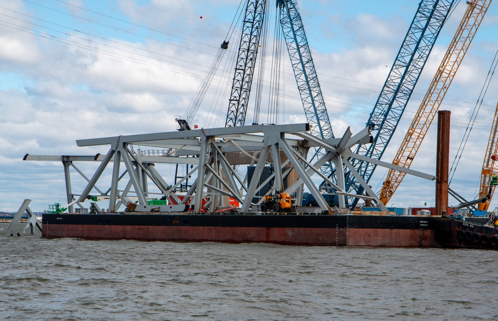 Crews work to clear wreckage from the Francis Scott Key Bridge