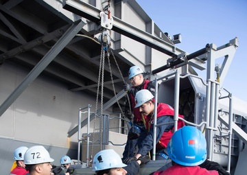 Sailors load a rolling airframe missile launcher