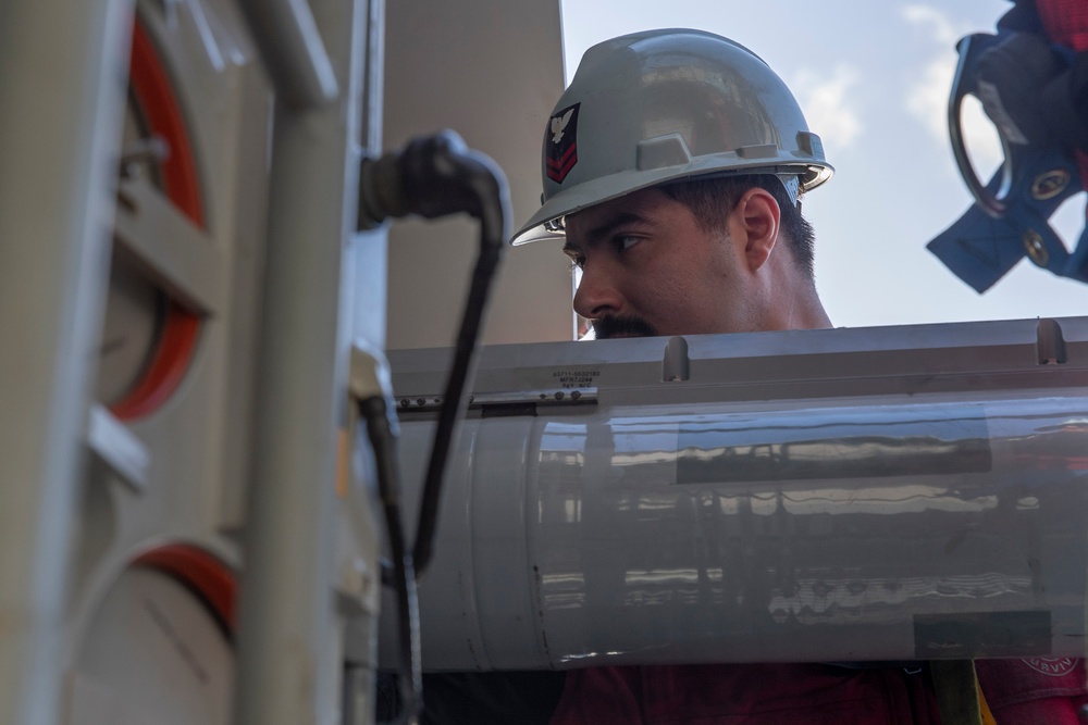 Sailors load a rolling airframe missile launcher