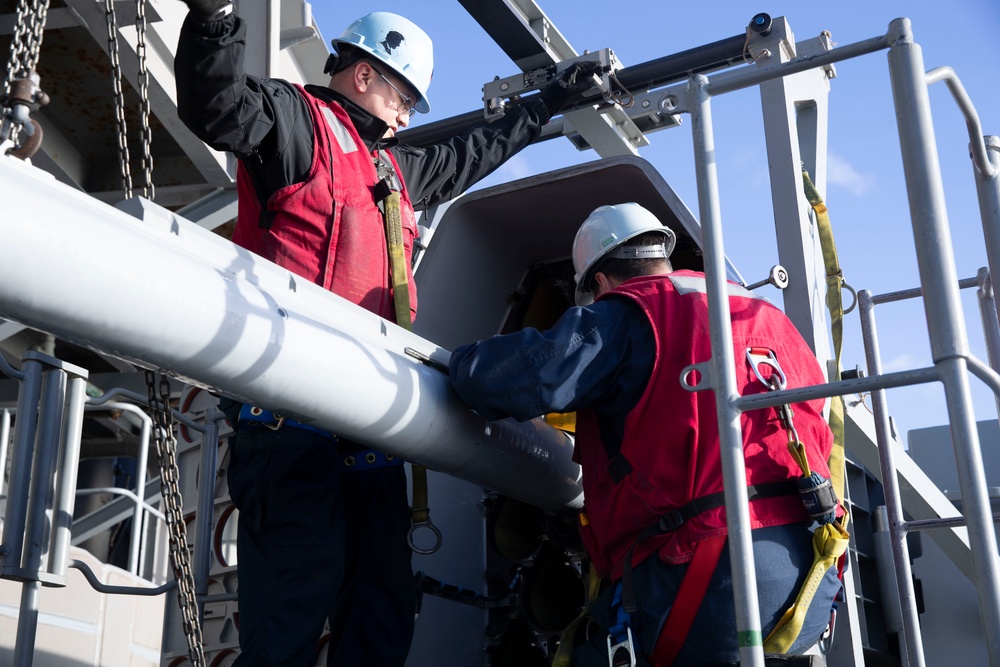 Sailors load a rolling airframe missile launcher