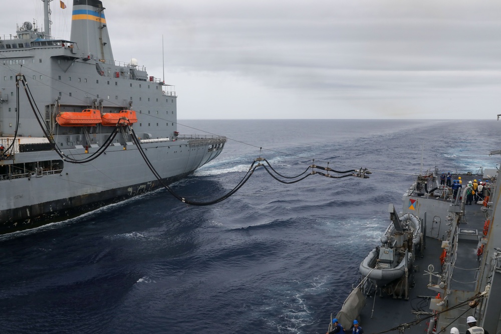 Sailors aboard the USS Howard conduct a replenishment-at-sea with USNS Yukon in the Philippine Sea