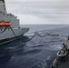 Sailors aboard the USS Howard conduct a replenishment-at-sea with USNS Yukon in the Philippine Sea