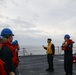 Sailors aboard the USS Howard conduct a replenishment-at-sea with USNS Yukon in the Philippine Sea