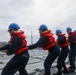 Sailors aboard the USS Howard conduct a replenishment-at-sea with USNS Yukon in the Philippine Sea